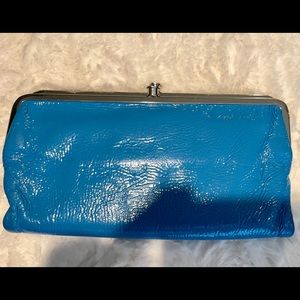 HOBO brand wallet. Shiny Turquoise color black and white inside fabric.